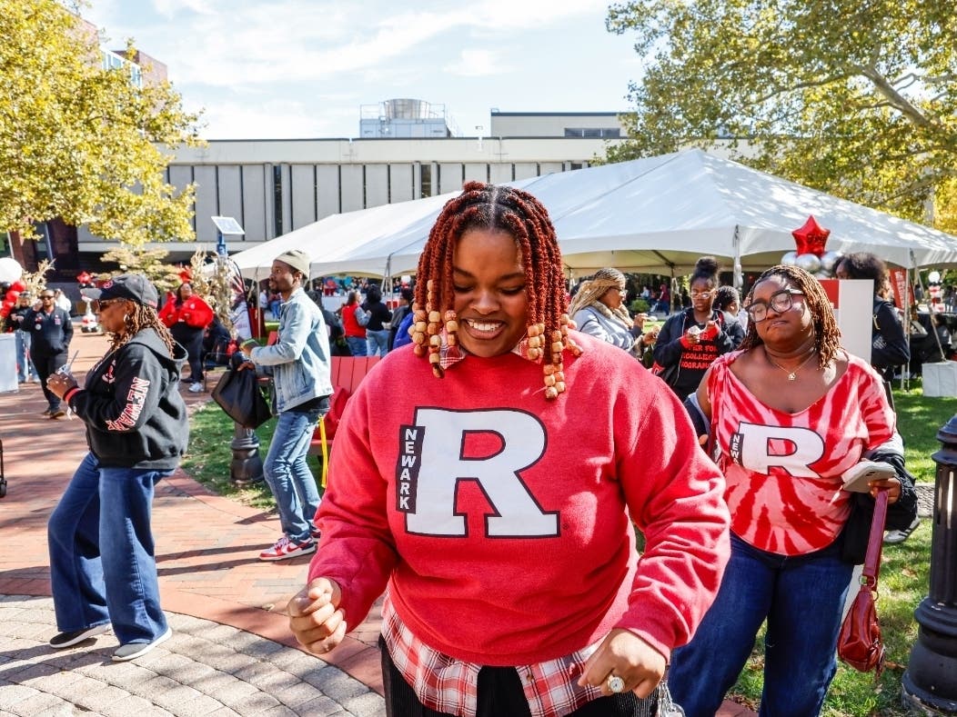 Visitors line dance at Rutgers-Newark's 80-anniversary homecoming celebration.