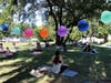 Park School Assistant Principal Melisa Stoller leads families in a yoga session.