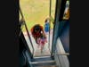 A Park School student gets help getting on a school bus during an orientation.