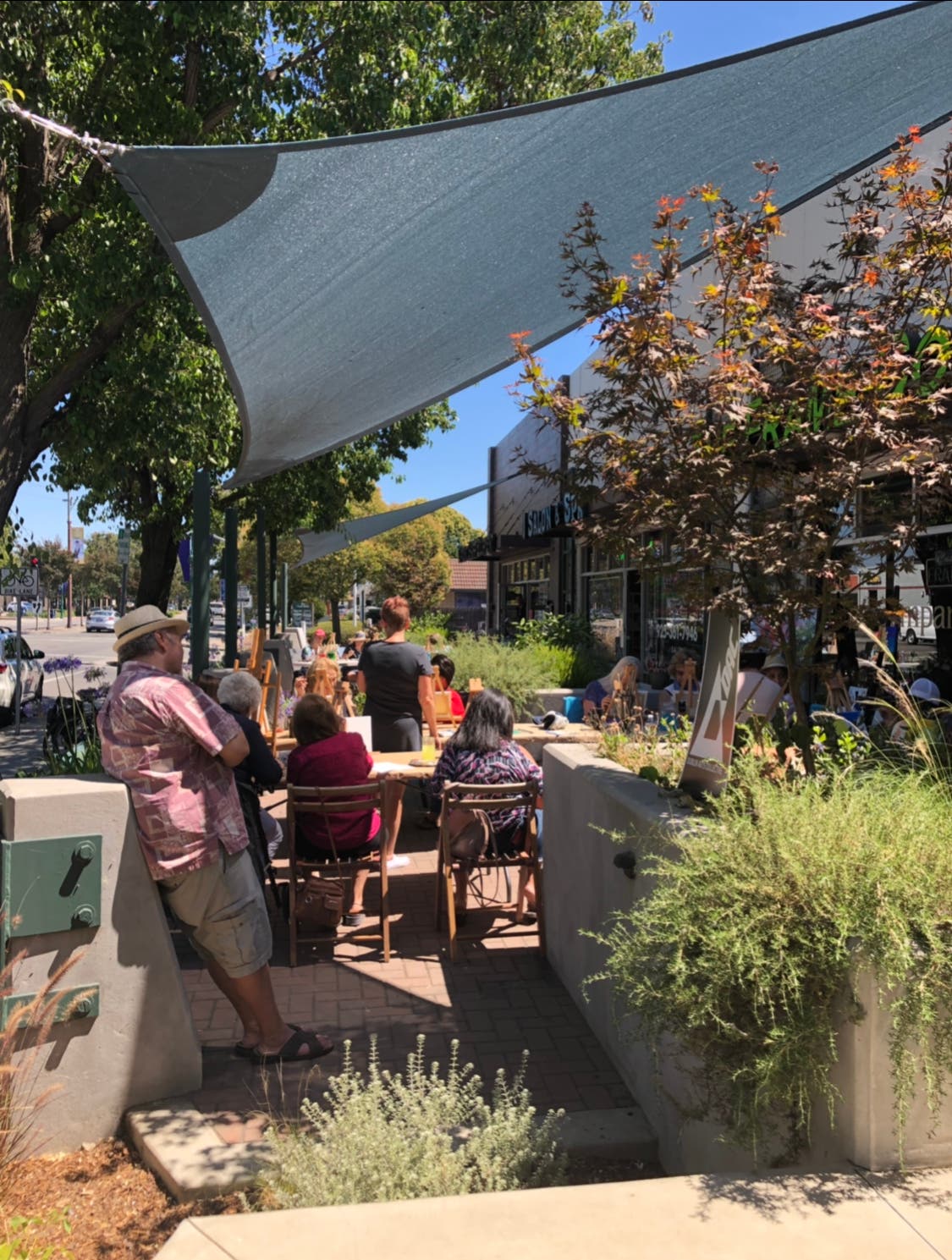 Participants painting on the patios of The Frame Company & Gallery, Three Sheets Beer 