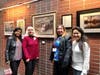 Artists pose with a Watercolor painting by Charlotte Severin titled "Aborigini Library". Left to right Usha Shukla, Charlotte Severin, Vanessa Thomas and May Yin Giang