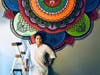 Artist Swati Rastogi in front of one of her trademark mandalas