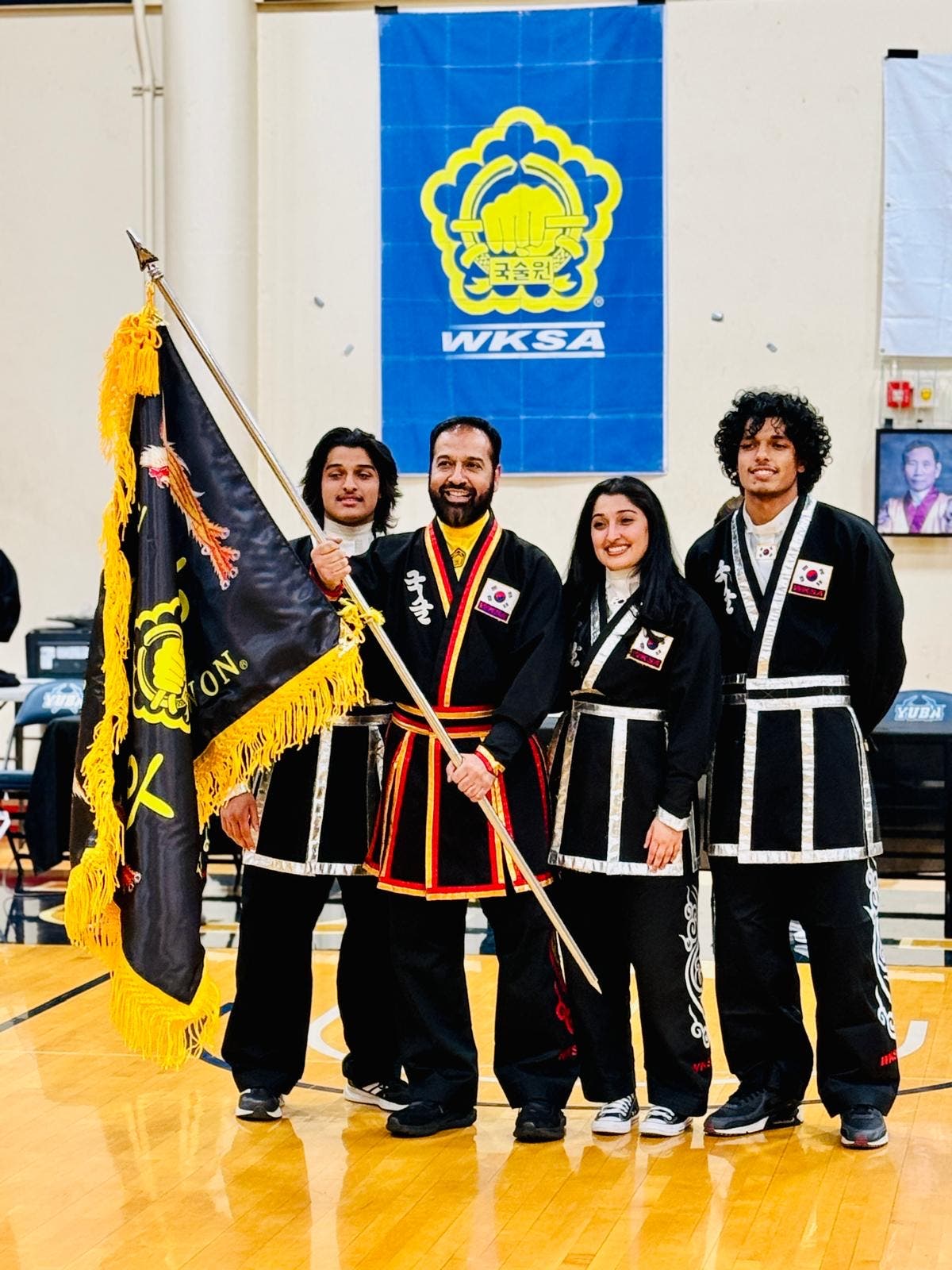Martial artists with winning flag at Pacific Coast Tournament