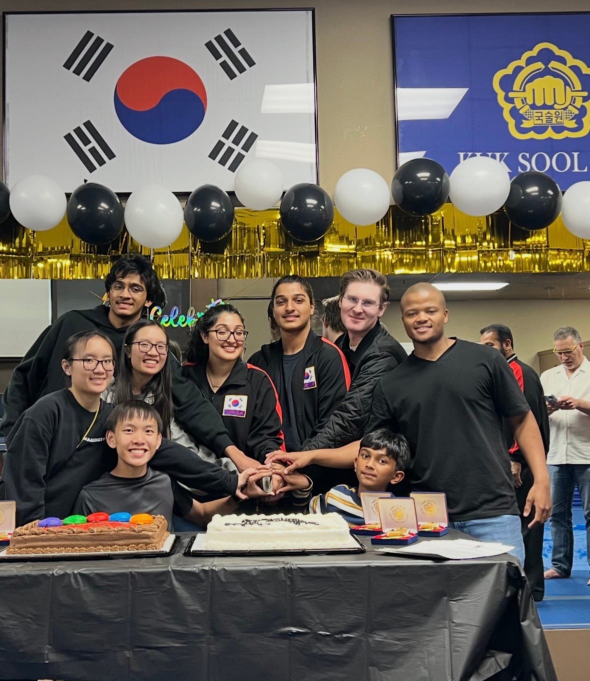 Martial arts celebrating their win cutting a cake