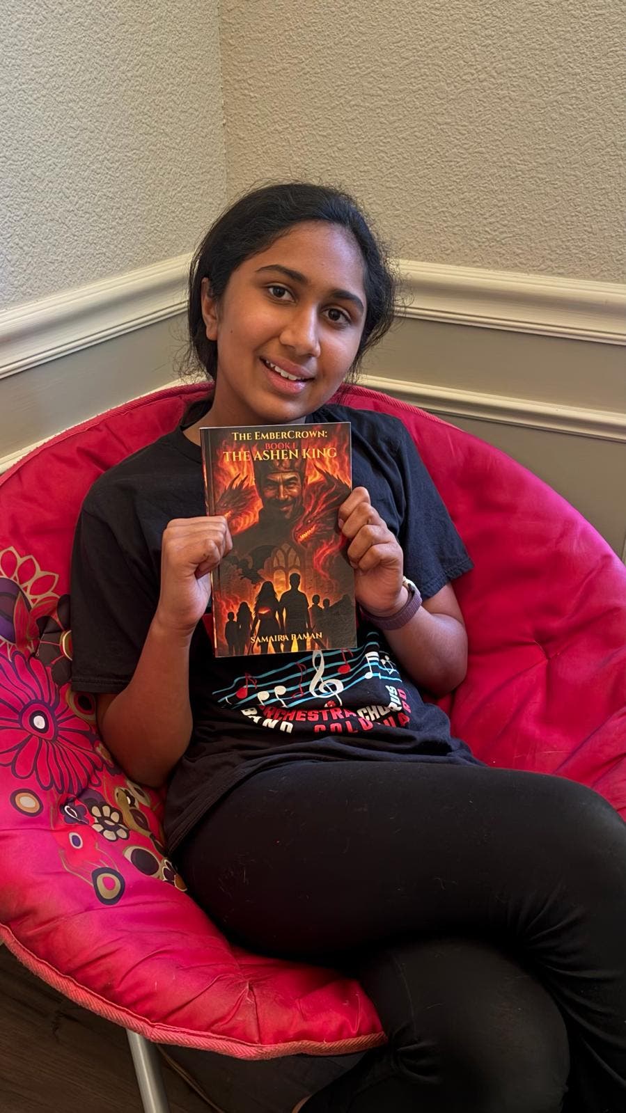 Teenage author holding her fantasy novel