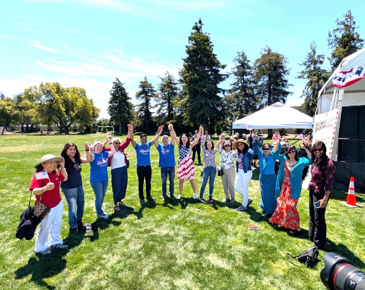 Group of people with arms in the air