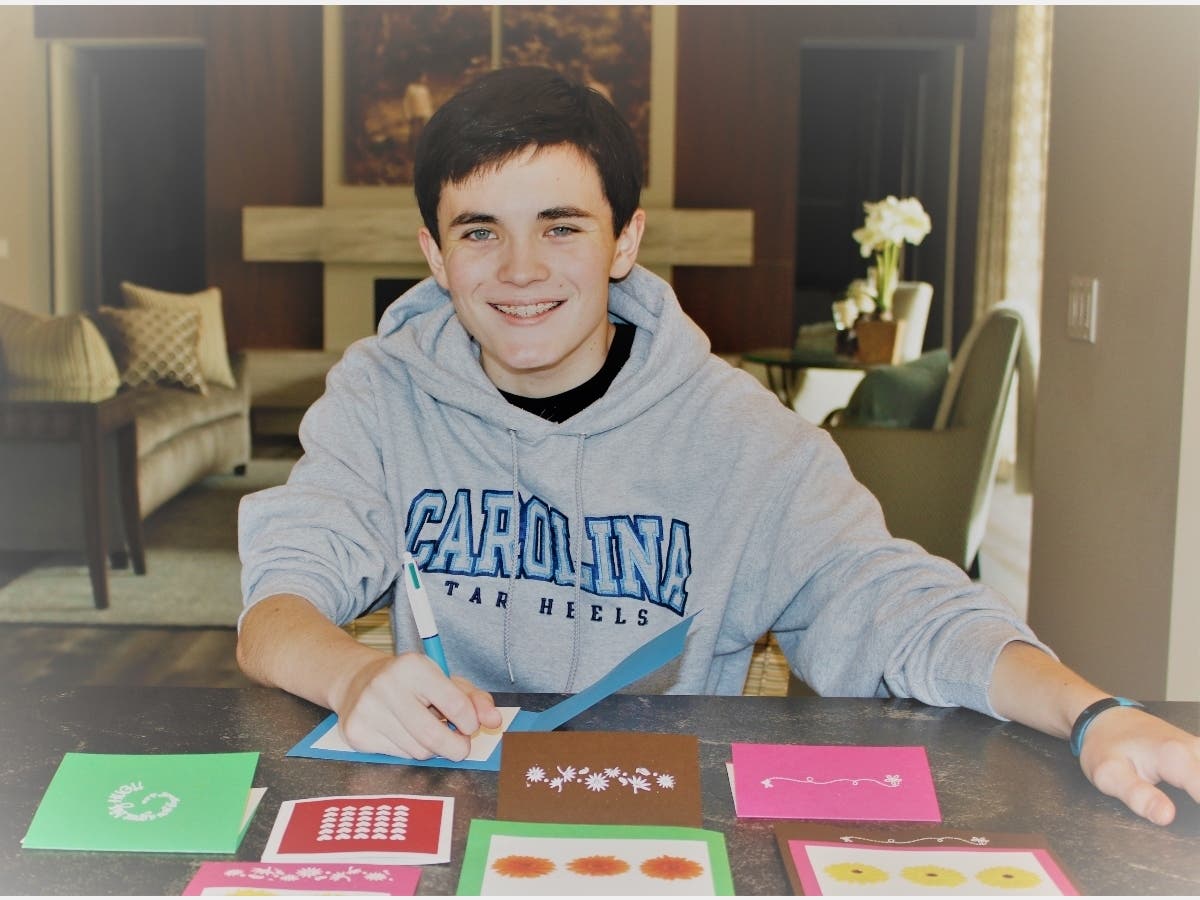 Assisteens volunteer Christian Brandt prepares greeting cards designed by fellow Assisteens volunteer Kylie Tang for Telecare clients’ and senior living residents’ enjoyment.