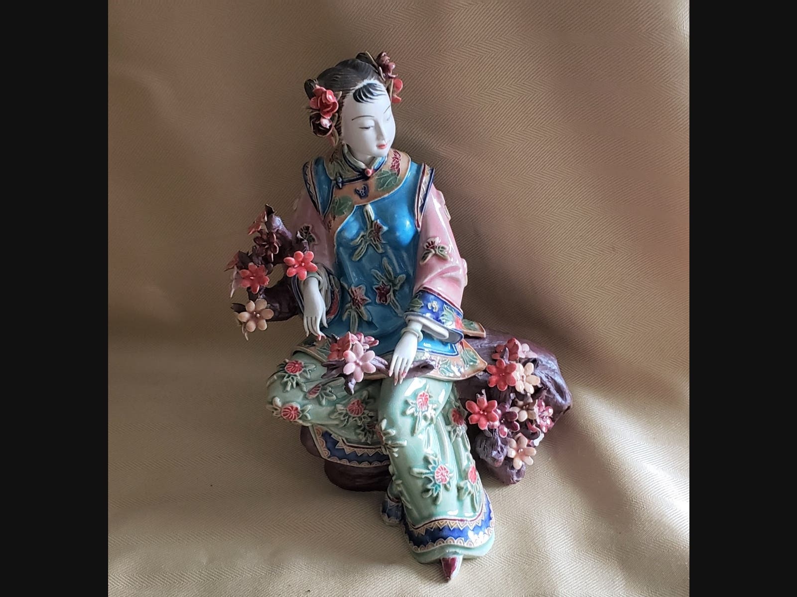 This diminutive Chinese Plum Blossom porcelain figurine includes a handwritten poem inset.