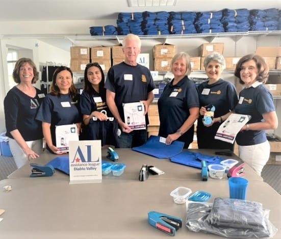 Corporate Partners Co-Chairman Linda Mercer (l) thanks Walnut Creek Rotary members (l-r) Carolina Alas-Hemphill (team leader), Michelle Alas, Gordon Fischer, Cathy Durfee, Shalini Lugani and Trudy Triner at a recent Operation School Bell bagging event.