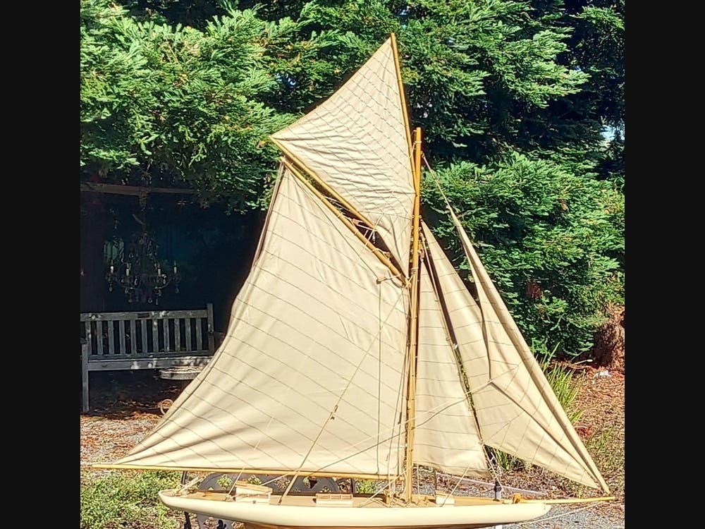 Wouldn’t the schooner seen here, resting on folds of fabric resplendent with varied shades of blue, grace your mantle?