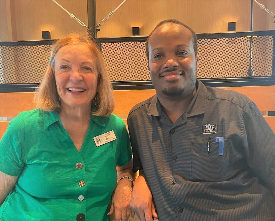 Assistance League Diablo Valley President Arlita Smith thanks General  Manager Demario Coaxum for California Fish Grill’s philanthropic support.