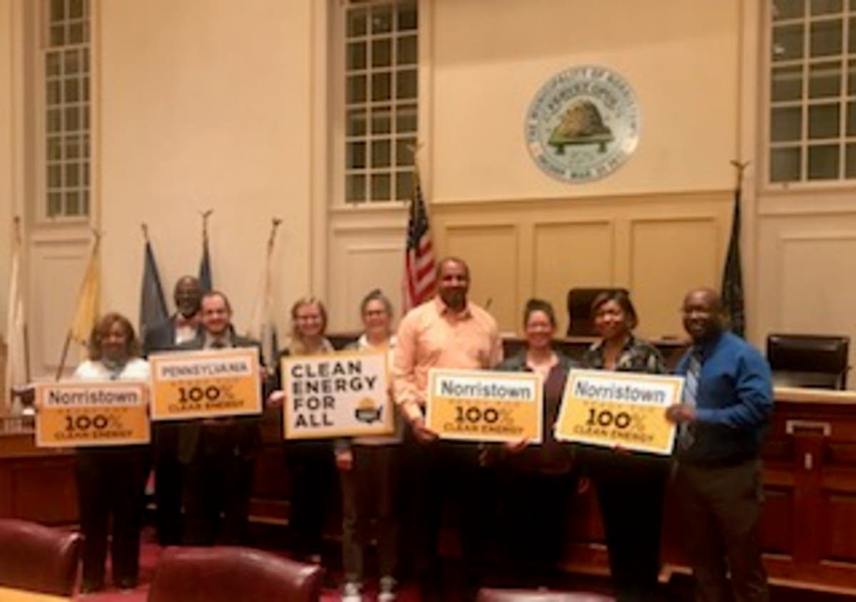 Norristown leaders gather together after making a commitment to transition to renewable energy.