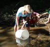 Maya van Rossum helps release juvenile eels into the Pickering.