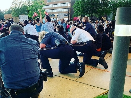 Police officers knelt alongside students and demonstrators in Abington on Thursday protesting the death of George Floyd. 