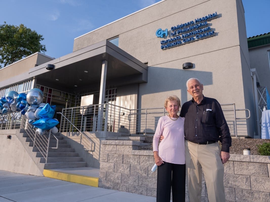 Philanthropists Nicholas and Athena Karabots stand before the new CHOP Primary Care Center in Norristown. 