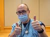 Dr. John Russell, the chair of Family Medicine at Abington Hospital, gives two thumbs up as vaccines are distributed.