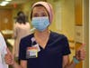 Marisa Lazo Rivera, a critical care nurse at Abington Hospital-Jefferson Health, gives a thumbs up as the first doses of the new coronavirus vaccine are administered.