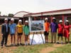 Principal Scott Baker, HJMS students, and Assistant Principal Anjanette Belmonte stand next to architect’s rendering.