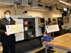 Tunxis Academic Advisor Jordan Domkowski and Asnuntuck Advisor Kellie Payne hold checks presented to their college's program from the Haas Foundation.