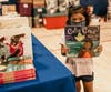 A young shopper finds just the book she was looking for at the 2022 Back to School Shop event.