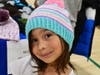 Participant in 2024 Back to School Shop event strikes a pose with her new handmade hat!