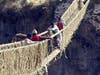 Painstakingly weaving the cords of the rope (grass) bridge