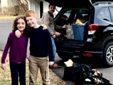 Lydia, Jack and Gene Ciccimaro at Newtown Quaker Meeting loading car with 100 "Weekend Bags" of food to take to the Trenton Area Soup Kitchen (TASK).