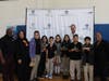 (L to R) Latame Phillips, Executive Director of Hunger Busters, Principal Sandra Espinoza, and Robert T. Jones, Founder & CEO of Roots Food Group, with students at Botello Elementary School
