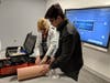 Students learn how to pack a wound and how to apply a tourniqet during a Stop the Bleed workshop.