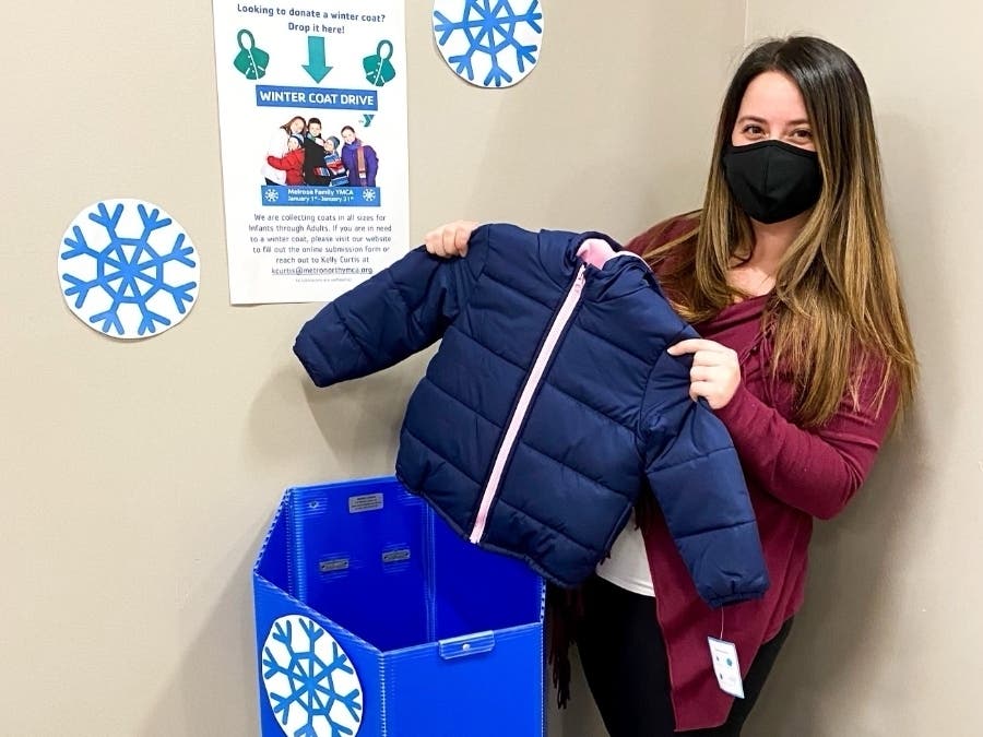 Melrose YMCA Membership Director, Kelly Curtis, assisting with winter coat donations at the Y.