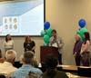 Alex Tsao, PhD, CACCC Co-Executive Director at podium. Looking on are (L-R) Jolie Lou, BHB Member; Patti Andrade, BHB 1st Vice Chairperson; Jeanne Wun and Jiayu Jeng.
