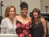 Event co-chairpersons Irene Hall (left) and Lauren Berke (far right) thank Onestie Jackson for sharing an inspiring story of the Y’s impact on her life.