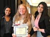 Ashley Biddle (center), the Y's Civic Engagement Program Coordinator, celebrates being honored with the Gail C. Jochen YMCA Values Award at the Model UN conference with delegation officers Alessa Alex and Skriti Nakkeeran from Freehold High School.