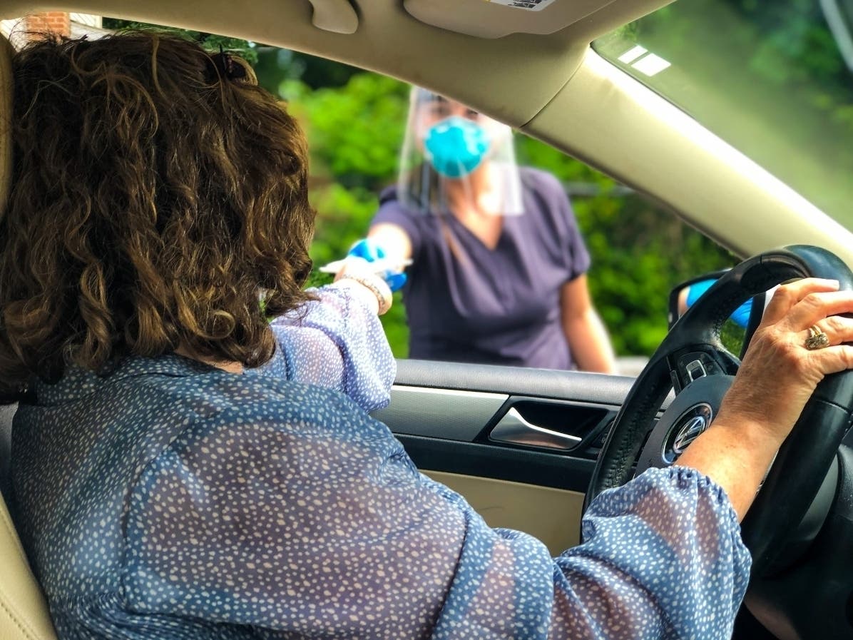 VNA Certified Medical Assistant Ali Robles provides a COVID-19 test kit to a local resident at the Red Bank Family YMCA, now a site for testing three days a week by the Visiting Nurse Association of Central Jersey Community Health Center.