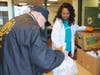 Jo Ann Rountree, senior director of community outreach for the YMCA, distributes meals at the Freehold Borough YMCA to help strengthen the community. 