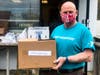 YMCA volunteer Tom McGrath lends a hand with distributing emergency food boxes at YMCA of Greater Monmouth County's Bayshore Family Success Center in Leonardo.