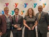 Togetherhood Champion Award winners Jayden and Yulissa Gomez with Y President and CEO Laurie Goganzer and event Chairman Michael Wright.