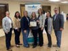 Representatives from Middletown Township present an award recognizing the Bayshore Family Success Center's 10th anniversary.