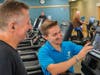 Y staff help members learn how to make the most of strength-building equipment.