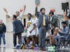Coach Keenan McMiller raises his arm in triumph.