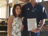 Photograph of Mrs. Aimee Luce and Dr. Drew Luce following the presentation of the Resolution. From Left to Right: Aimee Luce & Dr. Drew Luce