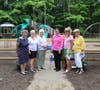 Members of the Woman's Club of Colts Neck and members of the Collier Board pose with Sr. Debbie, Executive Director of Collier Youth Services, in front of the Inclusive Playground