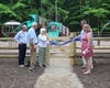 Diana Piotrowski and her family cutting the ribbon to officially open the Collier Inclusive Playground