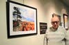 Lloyd Eby of Cheverly poses with his piece, “Hawk,” during the Digital Photography Club of Annapolis artists’ reception 