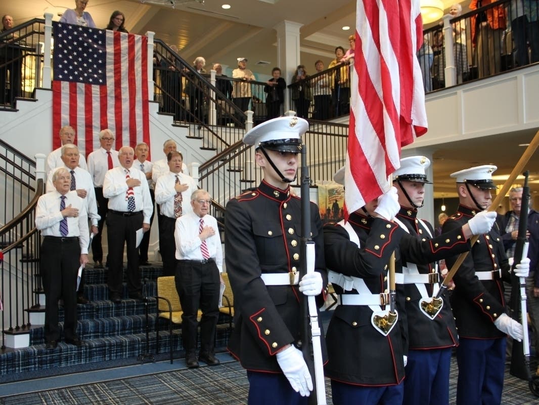 The Calvary United Methodist Church Men’s Choir sings “The Star-Spangled Banner” as the Northeast High School Marine Corps Junior ROTC Color Guard presents the colors at the Veterans Day Celebration honoring 41 Veterans living at Brightview Senior Living.