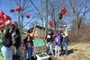 Amir's family lifts balloons by his bridge.