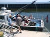 The team loads their Baykeeper boat with 1 million oysters on Tuesday, July 16.