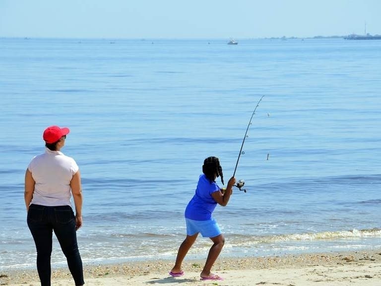A young lady goes fishing at Bayshore Waterfront Park in Port Monmouth.