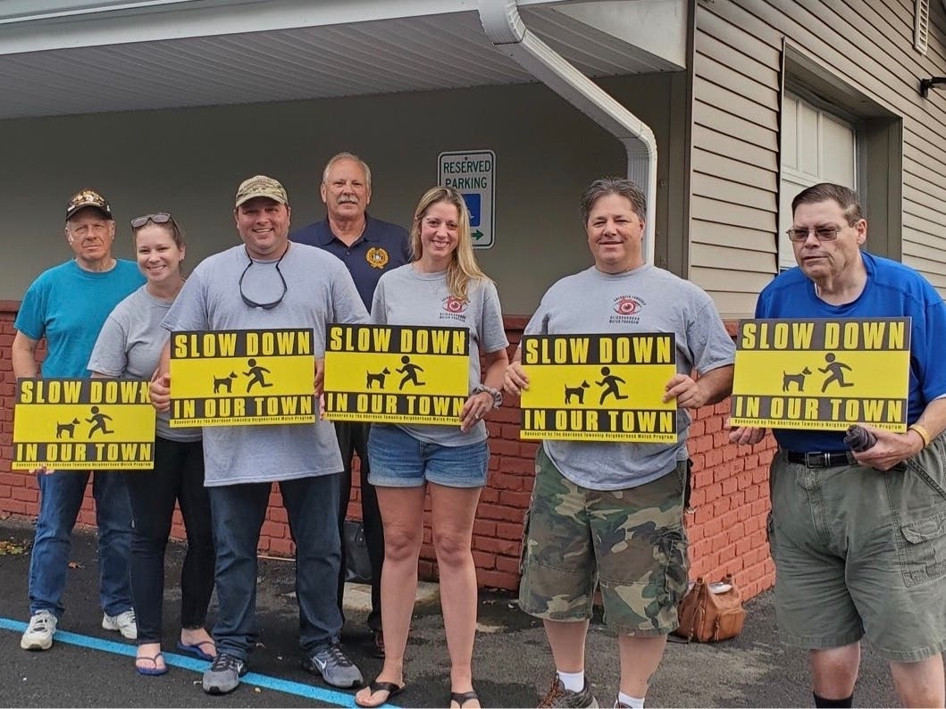 Aberdeen Police Chief Rick Derechailo with Geniton, center, and fellow Cliffwood Beach residents.