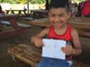 Derek Soto, 5, from Franklin, NJ shows off how kids collect credentials at Field Station to win prizes whey they leave.